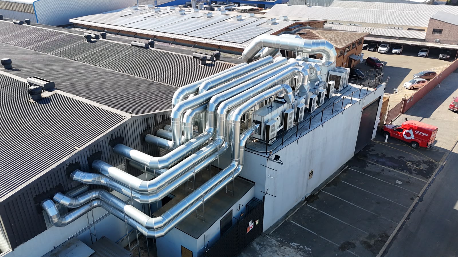 Rooftop HVAC ducting and air handling units serving the facility