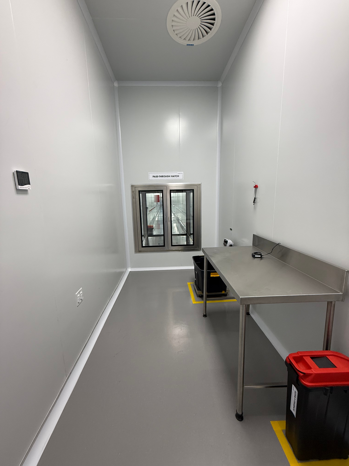Material pass-through hatch between processing rooms